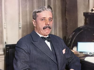 Arnold Bennett sitting at his desk