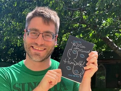 Charlie Fish holding one is his short story books