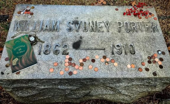 O Henry's Headstone with pennies on it