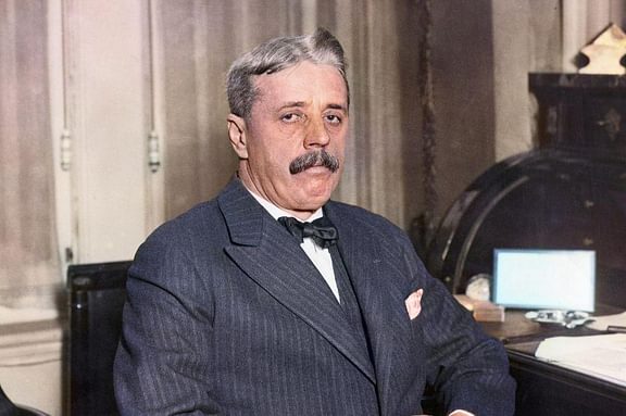 Arnold Bennett sitting at his desk