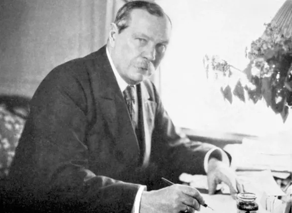 Arthur Conan Doyle writing at a desk
