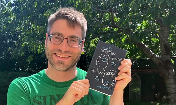 Charlie Fish holding one is his short story books