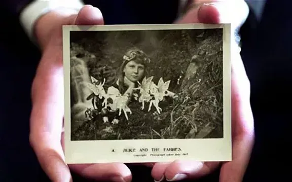 Someone holding a Cottingley Fairy photograph